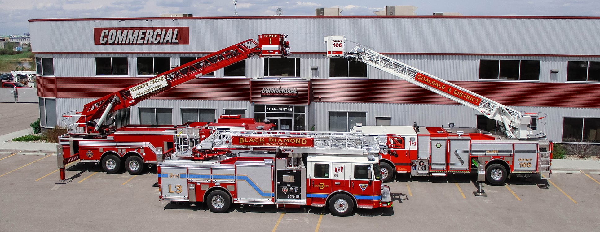fire trucks parked outside of commercial emergency equipment building